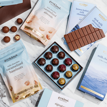 Load image into Gallery viewer, Quintessential Gift Box on marble with open bonbon box, milk chocolate bars, and caramelized nut pouches