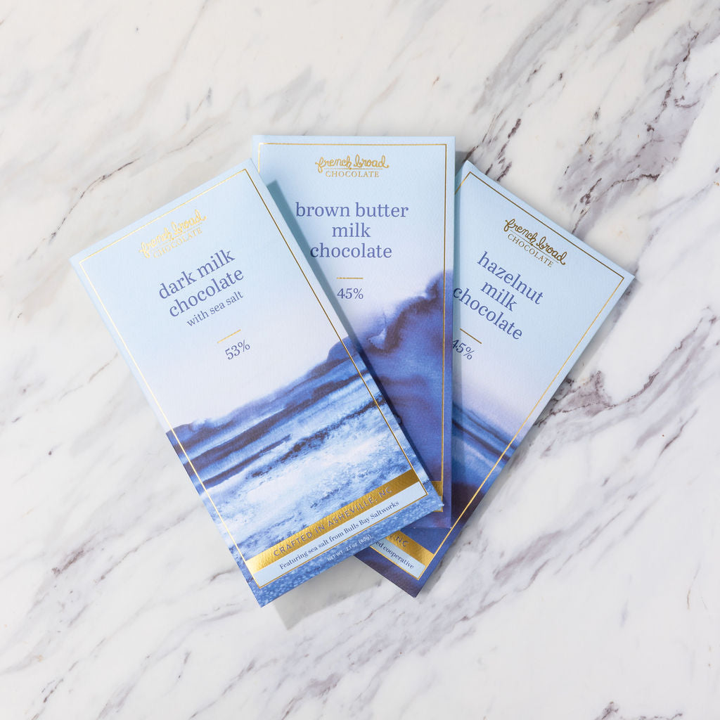 A fan of French Broad chocolate bars on marble